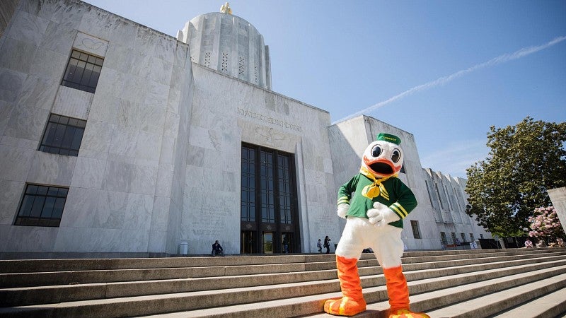 The Duck standing on the steps in front of the Oregon capitol building in Salem.