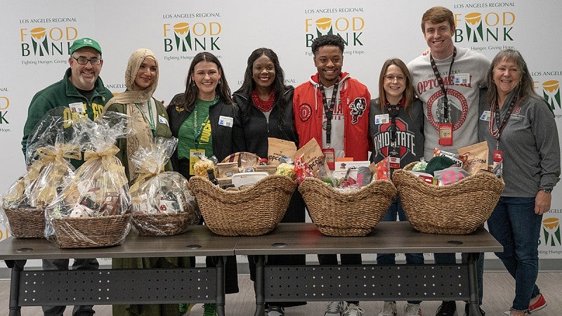 Representatives from UO and Ohio State pose for a photo after exchanging gift baskets.