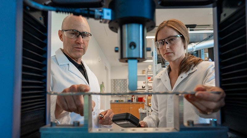 Bob Guldberg and Kylie Williams working in the lab