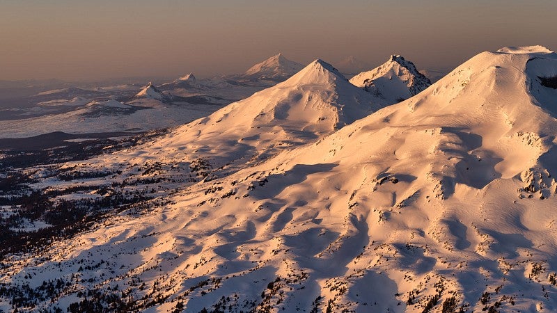 The snow-covered peaks of the Three Sisters and other Cascade mountains