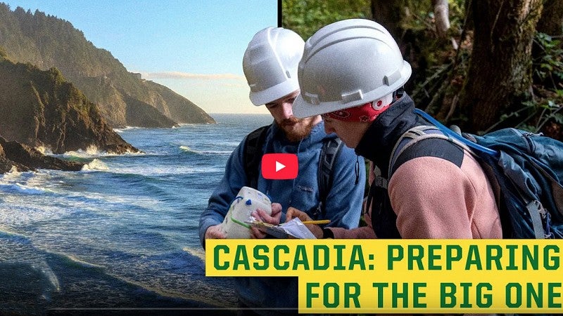 People in hard hats looking at a map near the coast