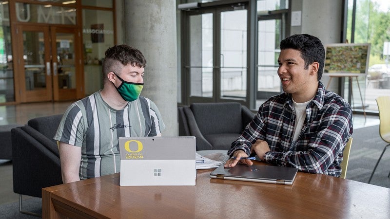 PathwayOregon peer mentors at a desk with laptops