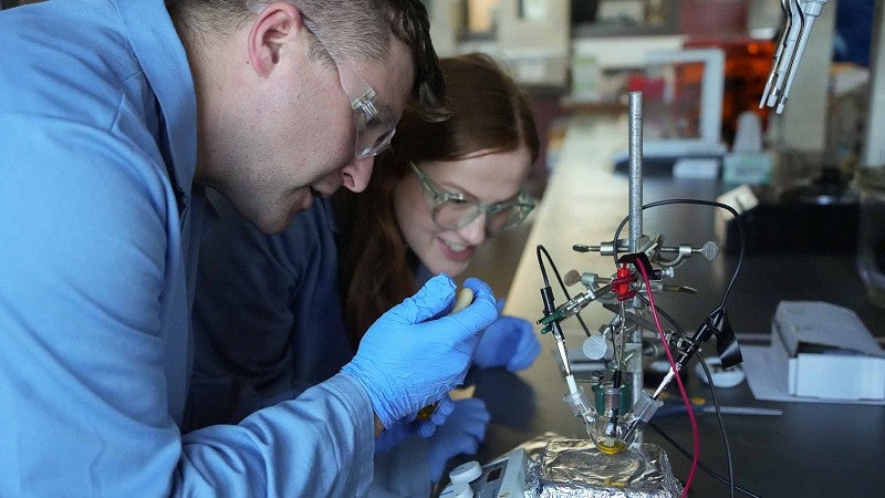 Researchers doing electrochemical tests on a sample