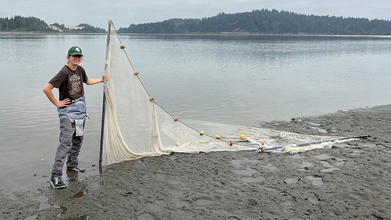 Hope Healey with seine net at the coast