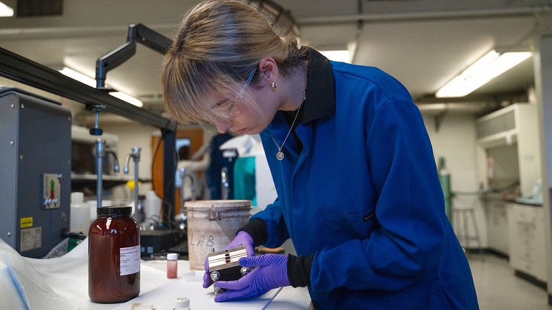 Researcher working on an electrochemical cell