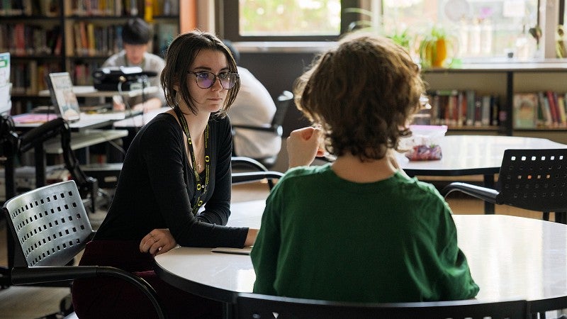 UO student intern meeting with middle school student
