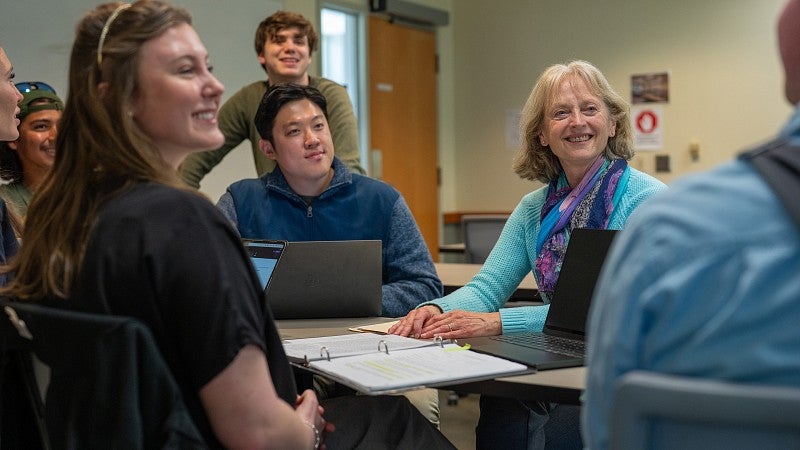Suzanne Rowe talking with a group of students