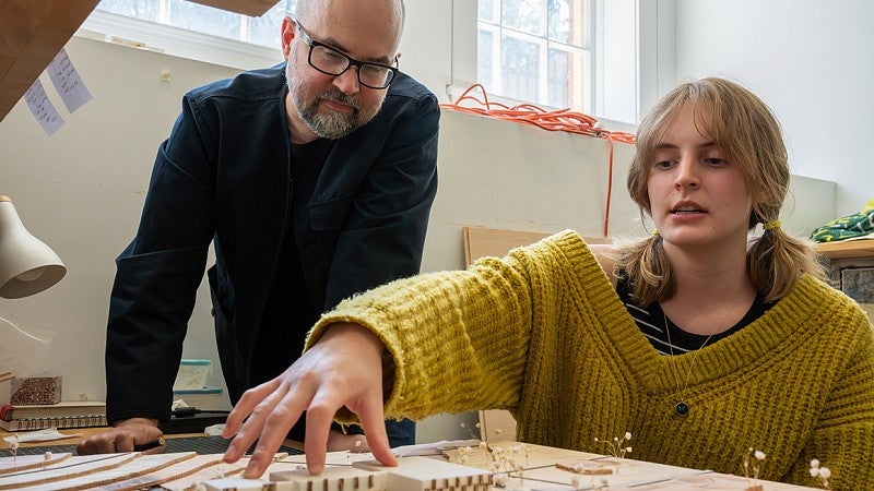 Professor and student with model of a hospital design