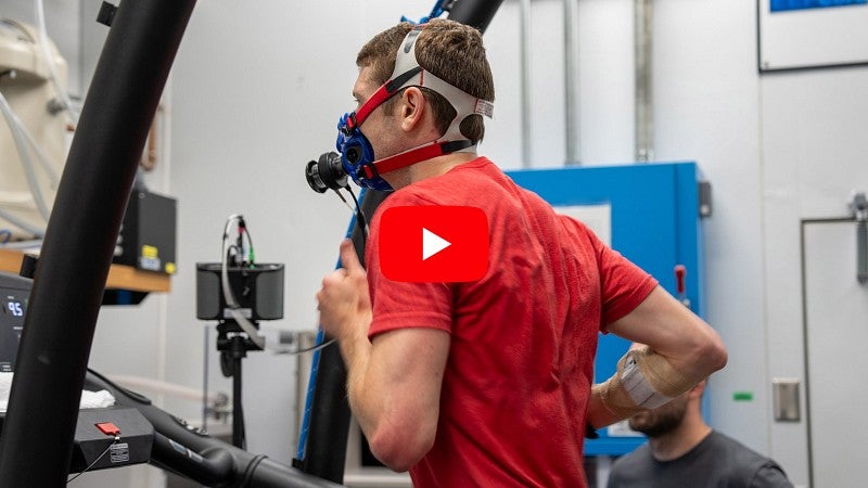 Man wearing respirator running on treadmill