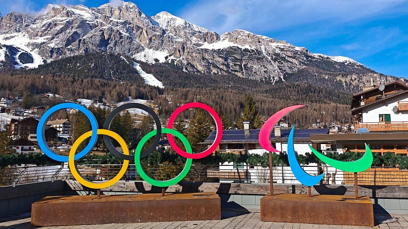 Olympic rings with snowy mountains in background