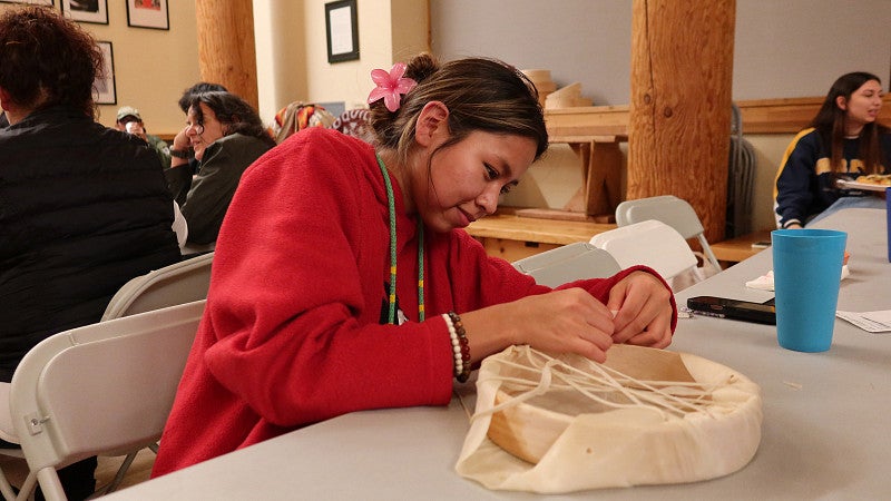 Woman make a traditional Native drum