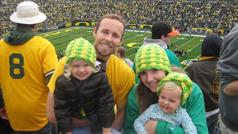 A family posing at a UO football game