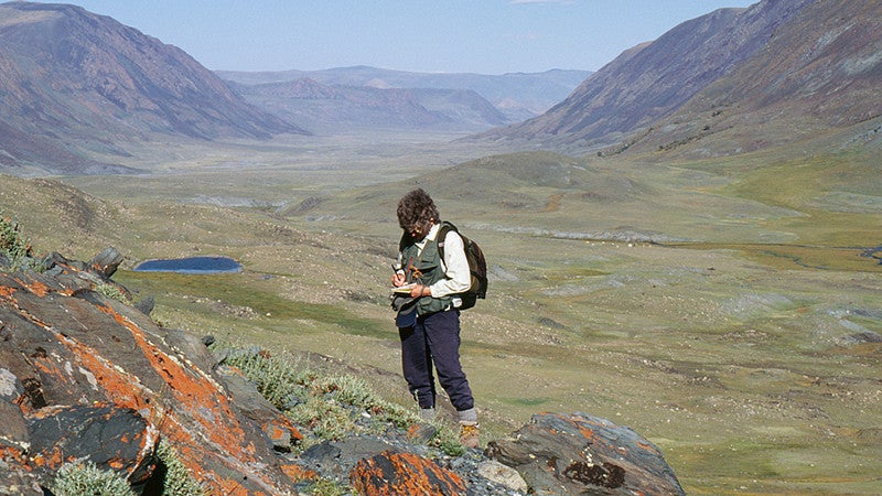 Professor Esther Jacobsen-Tepfer studying rock art
