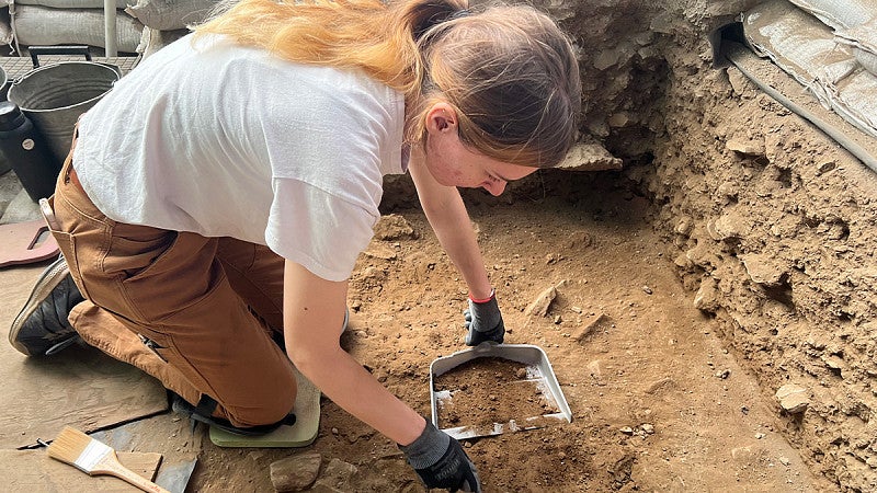 Student excavating at the Conley Caves Field School