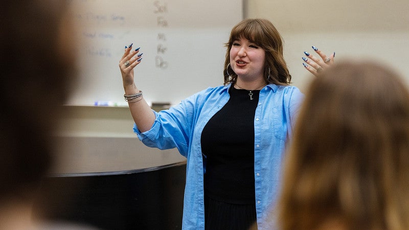 Student teacher in front of a high school music class