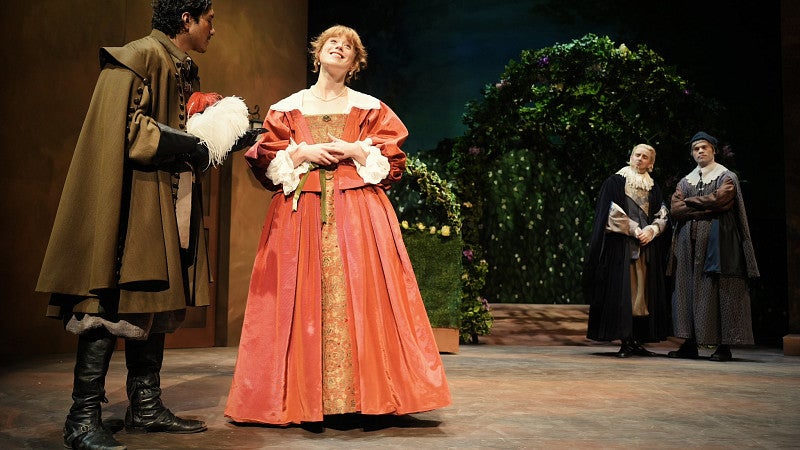 Students on stage in a production of Much Ado About Nothing