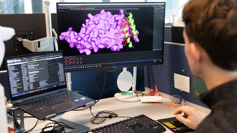 Student looking at an image of a molecule on a computer screen