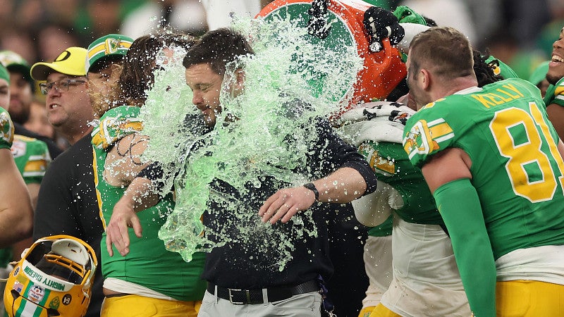 Football players pouring Gatorade over their coach