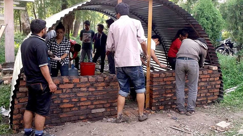 The Aashraya team building an emergency shelter