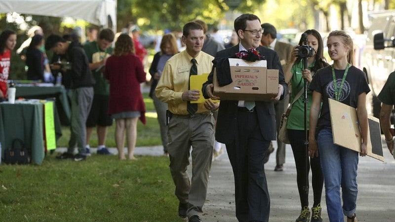 UO President Michael Schill lends a hand during Unpack the Quack