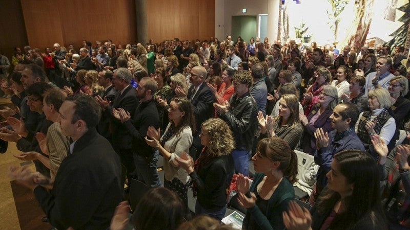 People standing and applauding