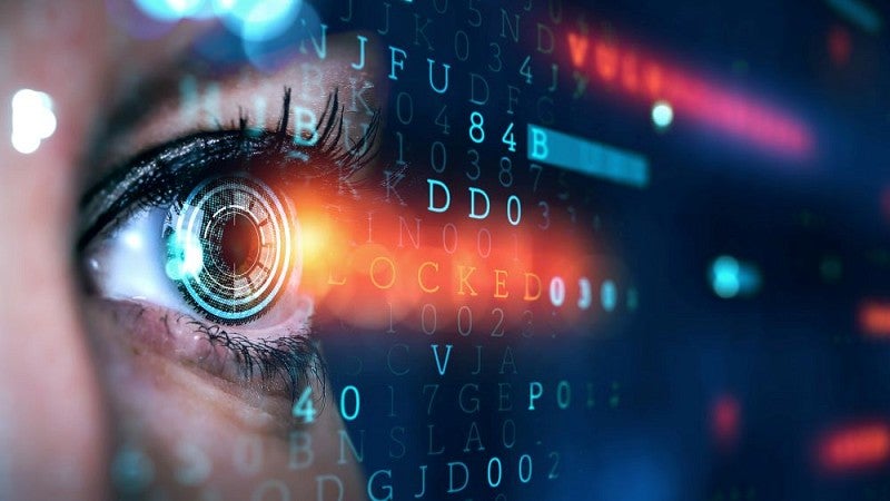 Stock image of an eye scanning computer code