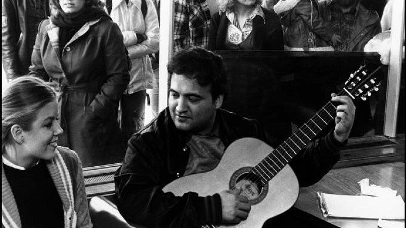 Between takes, John Belushi serenaded a young fan inside the fishbowl. . . (Photo courtesy of University Archives Photographs, UO Libraries.)
