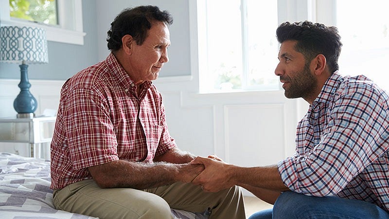 Alzheimer's disease patient getting comfort from his son