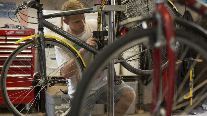 Working on a bike at the UO Bike Program