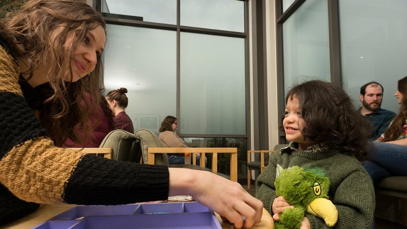 A graduate student works with a child in the UO's HEDCO Clinic.