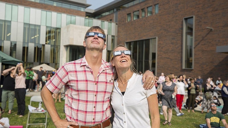 Bill Cresko and Cristin Huslander of the UO biology department watch the eclipse