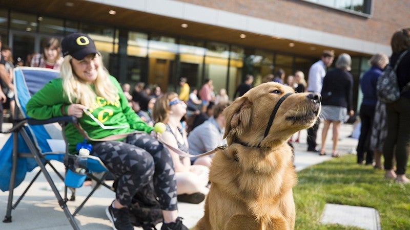 A curious canine watches the eclipse-watching crowd outside the EMU