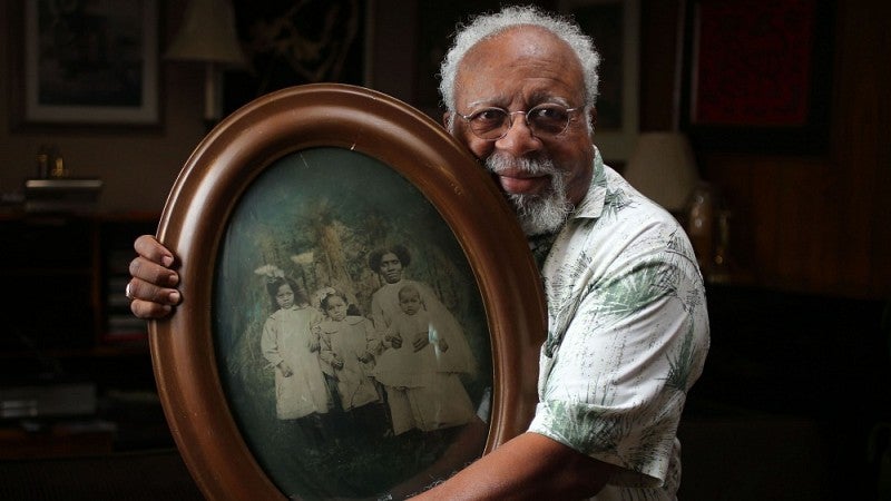 The Ed Coleman, retired UO English professor, holding a family portrait.