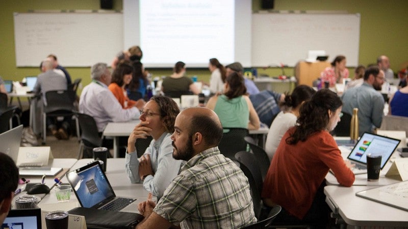 Participants at the 2017 Northwest Regional Summer Institute on Scientific Teaching at the University of Oregon discuss how to support improved student learning outcomes in the sciences and make other improvements to STEM education. Photo courtesy of Dan 