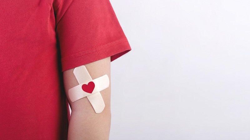 Man with bandage after giving blood