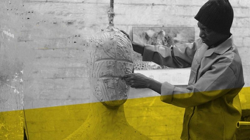 A Black artist working on a sculpture