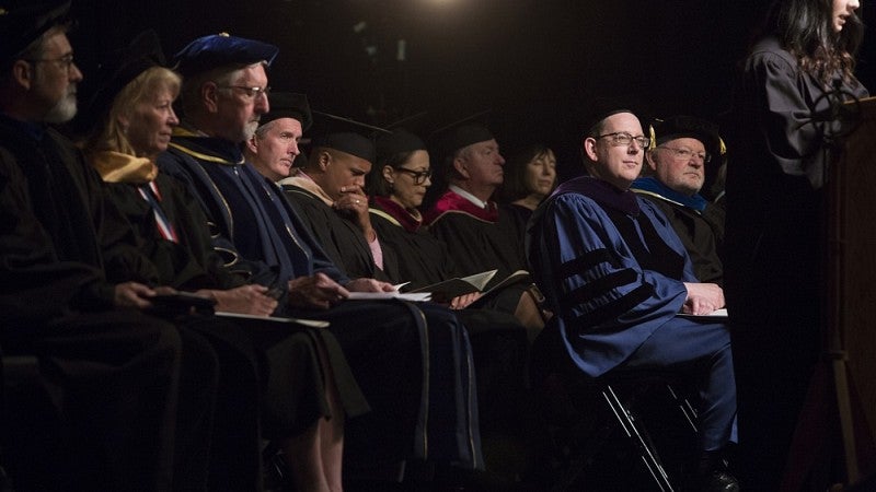 President Schill seated on stage