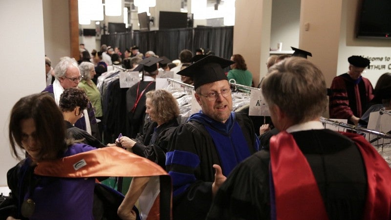 Faculty members picking up regalia