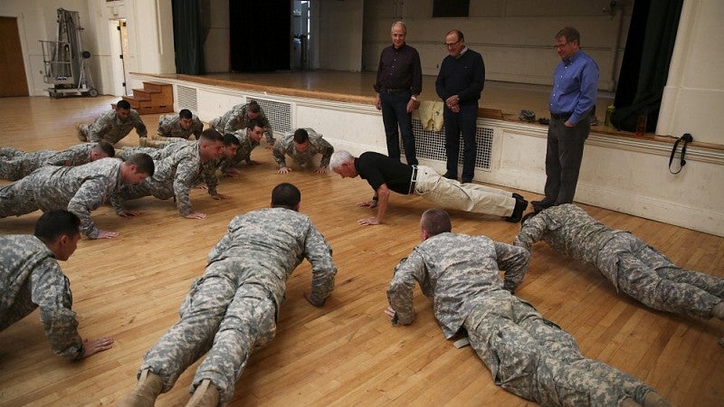 Doing 20 pushups with the squad ('65 classmates standing: Jim Abrams, Kent Williams and Joe Leahy)