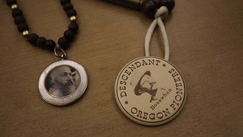 At left: Mala—a necklace and pendant with Rajneesh’s photo—were worn by many of his followers. The “Bosswhan” mala at right is constructed of rifle cartridge casings, expressing a Central Oregon neighbor’s opposition.