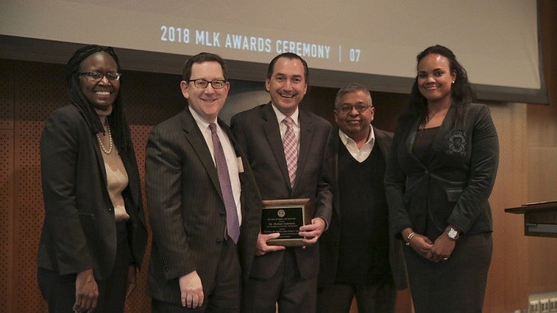 Institutional Transformation Award winner Michael Andressan (center)