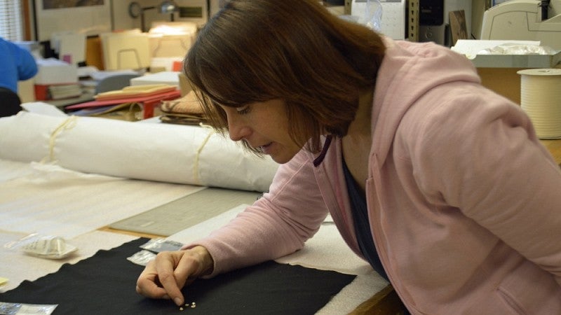 Anthropological collections manager Elizabeth Kallenbach examines ancient shell beads found at Fort Rock Basin