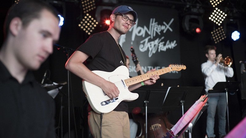 Band member playing guitar