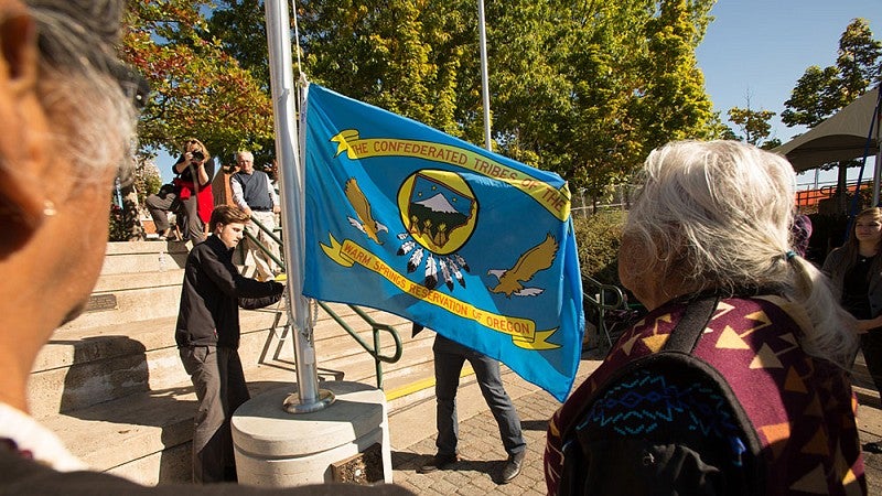 Raising one of the nine tribal flags around the EMU amphitheater