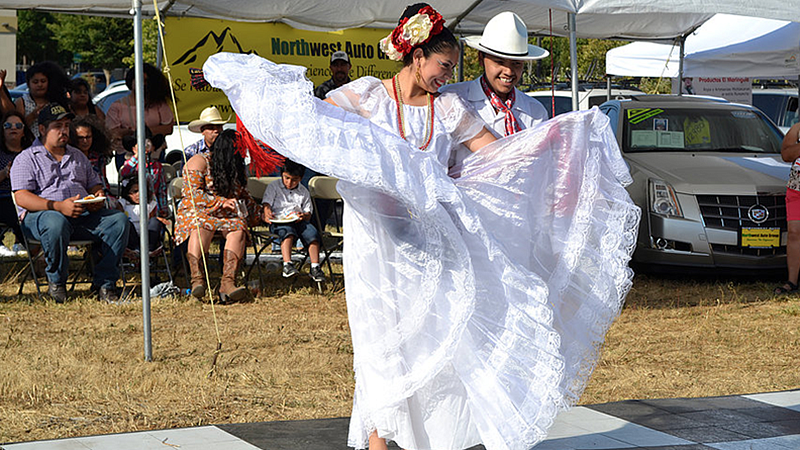 Image shows a couple dancing at a previous Noche Cultural event