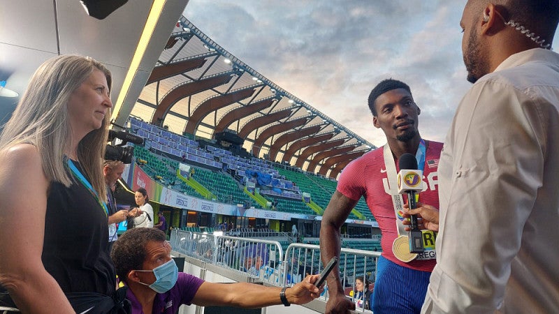 Reporters interviewing runner
