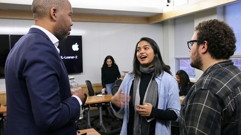 Coates speaking with students