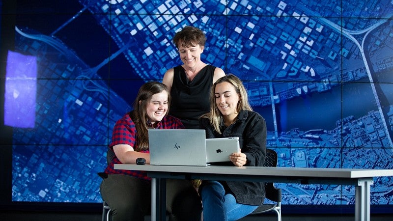 Professor and students studying data