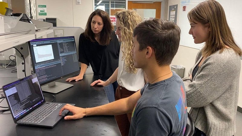 Professor and students in lab
