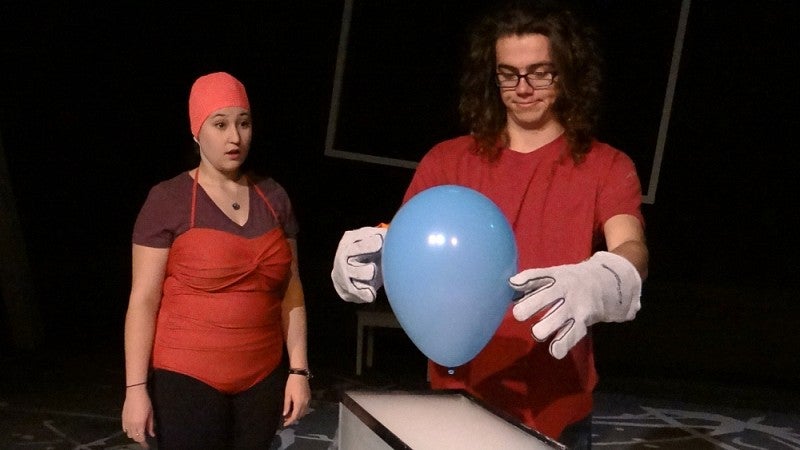 Actors in costume perform a science experiment during rehearsals for the new play 'Wonder if Wonder Why.'